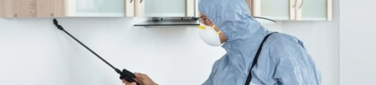 Termite treatment technician applying indoor pest control spray in Reno, NV