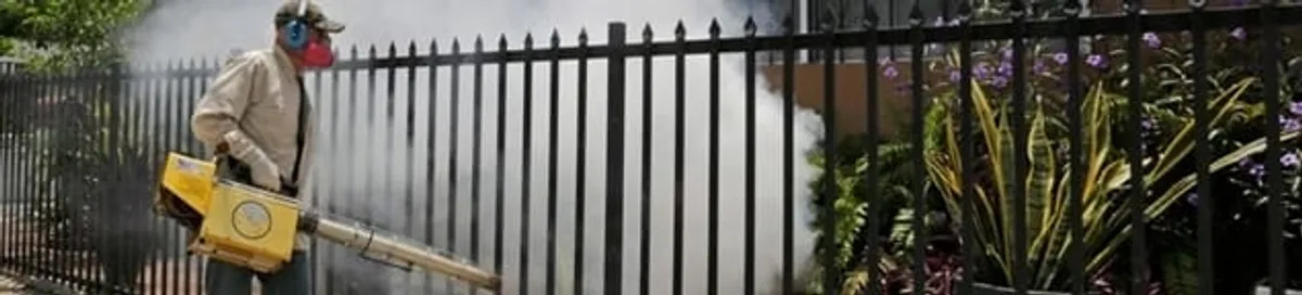 Mosquito control technician fogging a yard perimeter for mosquito reduction in Reno, NV